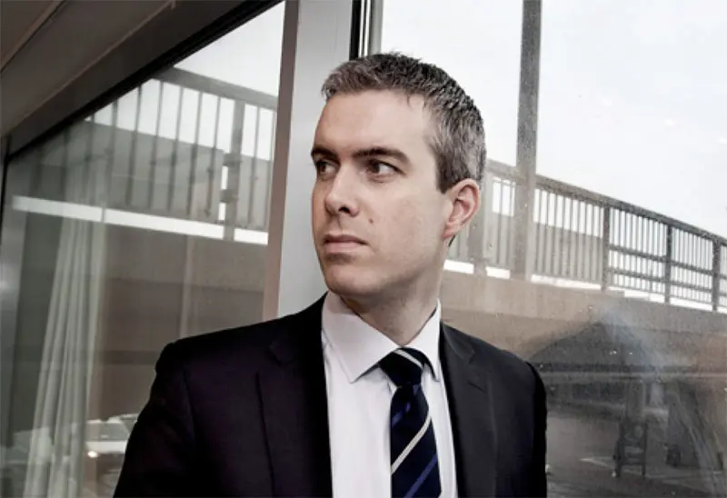 Portrait of man in front of window